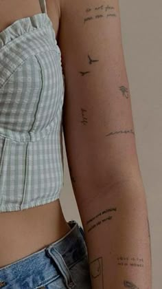 a woman's arm with tattoos on it