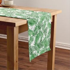 a red and white striped table runner on a dining room table with an orange bowl of fruit