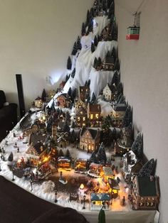 a christmas tree made out of miniature houses