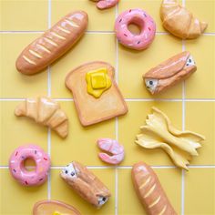 there are many different types of donuts on the tile floor, including bread and doughnuts