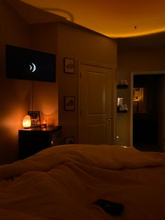 a dimly lit bedroom with the moon visible