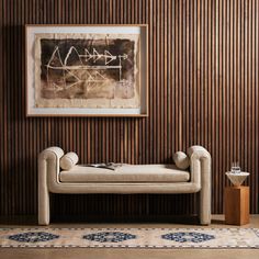 a living room with a couch, rug and painting on the wall in it's corner