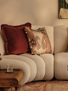 a living room filled with furniture and pillows on top of each other's sides