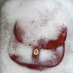 a red purse sitting in some white foam