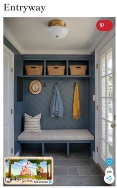 an entryway with a bench, coat rack and baskets