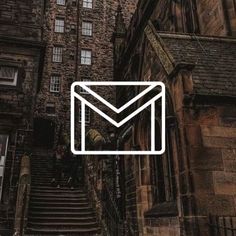 an email envelope is shown in front of a building with stairs leading up to it