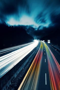 an image of a highway at night with long exposure and light streaks on the road