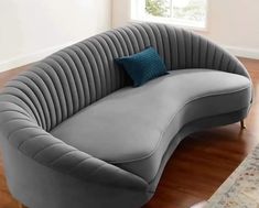 a gray couch sitting on top of a hard wood floor