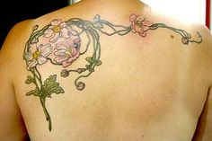 the back of a woman's shoulder with flowers on it