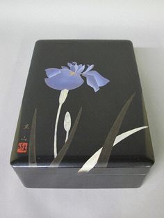 a black box with blue flowers painted on it