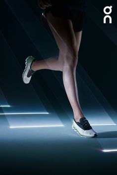 a woman's legs and shoes are lit up by the light from behind them