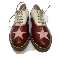 These adorable leather Charlotte Olympia oxfords feature a contrasting cream and burgundy star cutouts motif and goldtone trim with lace up front. Leather upper Lace up vamp Lightly-padded leather insole Contrasting star cutouts Goldtone eyelets, laces and welt border piping Rubber lug sole Made in Italy Clown Oc, Doc Marten Oxford, Charlotte Olympia, Lug Sole, Vintage Shoes, Beck, Olympia, Piping, Derby