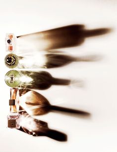 an image of some bottles and spoons on a white table with blurry background