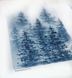 an image of some trees that are in the snow with blue and white paint on it