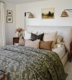 a large bed sitting in a bedroom next to two lamps on either side of it