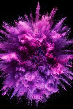 an explosion of colored powder in the dark