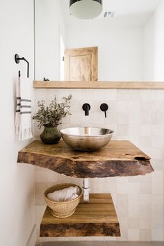 a bathroom sink sitting on top of a wooden counter