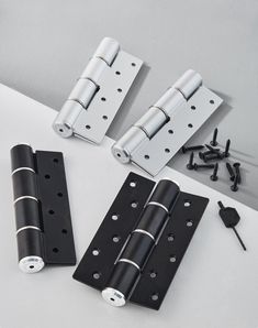 three different types of hinges and screws on a white surface with black hardware