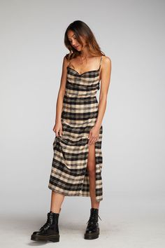 If you don't own Flannel in your winter wardrobe, have you ever gone shopping? Our Flannel Midi Slip Dress is equal parts seasonal and stylish, with a Side-Slit and some cleavage. Pair with black combat boots for an effortlessly edgy aesthetic. Black and beige are a combo of the season, so prepare for plenty of wear! Flannel Midi Slip Dress Fabric Content: 100% Cotton Model is 5'9" and wearing size small Imported Style: CW9354-LP Grunge Midi Dress, Plaid Dress Outfit Summer, Midi Slip Dress Outfit, Midi Dress With Boots, 90s Plaid Dress, Plaid Dress Outfit, 90s Midi Dress, Plaid Slip Dress, Tight Fitted Dresses