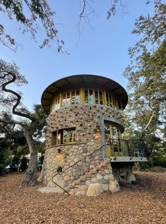 a round house made out of rocks in the woods