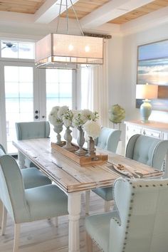 Coastal Dining Room Decor - Inspiration & Ideas Beach House Dining Room Table, Beach House Dining Tables, Coastal Conference Room, Aqua Dining Room Decor, Beachy Kitchen Table, Beach House Interior Dining Room, Light Blue Dining Room Ideas, Beach House Dining Room Ideas, Lake Interior Design