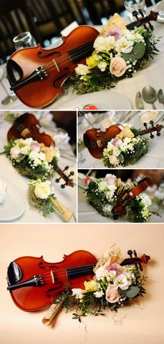 the violin is sitting on the table with flowers