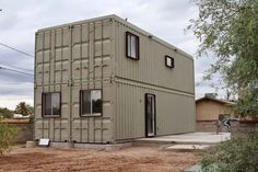 a house made out of shipping containers in the desert