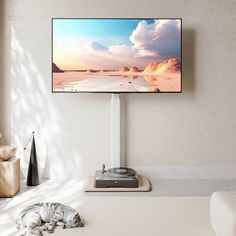 a flat screen tv sitting on top of a white table