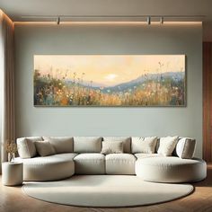 a living room with a large painting on the wall and a white couch in front of it