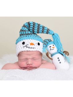 a newborn baby wearing a snowman hat