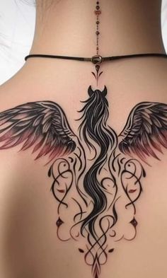 the back of a woman's shoulder with wings on it