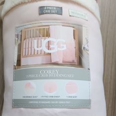 an advertisement for the ugg crib bedding set in pink and grey colors