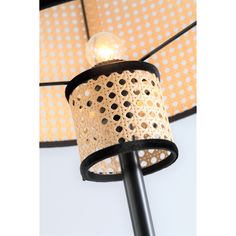 a black and white lamp with polka dot lampshade on the ceiling above it