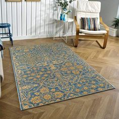 a living room with a chair and rug on the floor