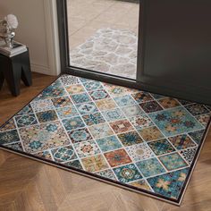 a multicolored area rug with an open door