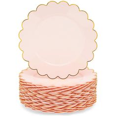 a stack of pink and gold plates with scalloped rims on top of each other