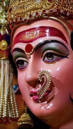 a close up of a face with jewelry on it