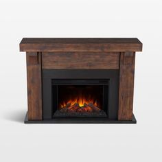 an electric fireplace with a wooden mantle and fire logs in it's center, against a white background