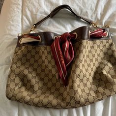 This Purse Has Been In My Closet For Over 15 Years. It Was My First Designer Purchase In Las Vegas Inside The Gucci Boutique . The Scarf Has A Few Marks , I Have Not Tried To Clean. One Spot On The Bag Has A Mark. The Purse Is In Great Condition. Please See Photos For Close Ups And Wear On The Leather.Inside Is Immaculate. No Rips Or Tears .Classic Gg Throughout. Gucci Hobo Bag Vintage, Designer Pre-owned Bags, Gucci Boutique, Gucci Hobo Bag, Gucci Vintage Bag, Wicker Purse, Gucci Scarf, Gucci Purse, O Bag