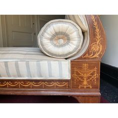 a bed with an ornate wooden frame and upholstered mattress on it's side