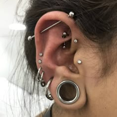 a woman with multiple piercings on her ear