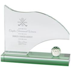 a glass trophy with a golf ball on it