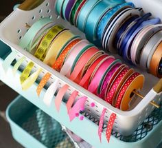 a rack filled with lots of different types of ribbons and spools on it