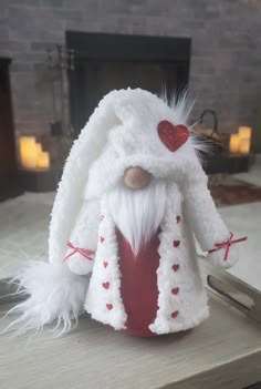 a white and red stuffed animal sitting on top of a table