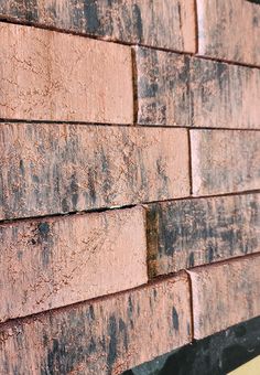 a close up of a brick wall on a building