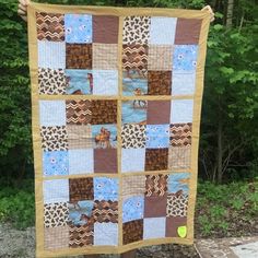 a person holding up a quilt made to look like a patchwork animal pattern on it