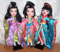 three dolls are standing next to each other