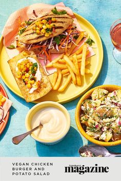 two plates filled with tacos and vegetables on top of a white table cloth next to flowers