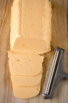 a block of butter next to a knife on a cutting board