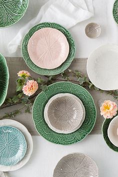 a table topped with lots of plates and flowers